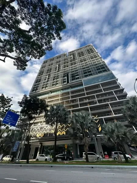 Exterior type: high-rise condominium; features: glass curtain wall, exposed concrete facade, recessed balconies, vertical fins, feature lighting at night, approximately 10-storey high-rise, manicured lawn, palm trees, surrounded by mature greenery, fronts a main road; style: modern.