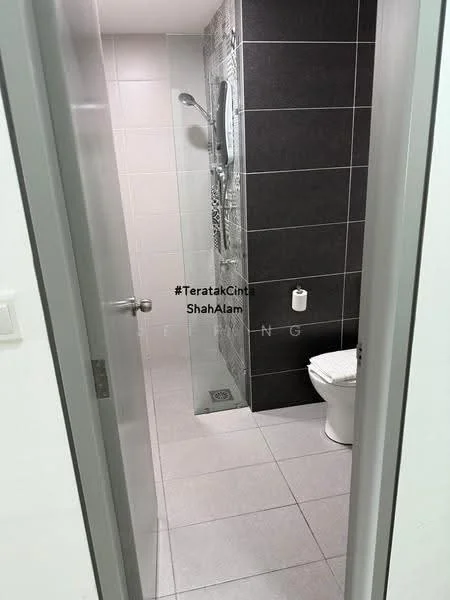 Bathroom features: white ceramic toilet, walk-in shower with glass enclosure, rain shower head, grey tile flooring, white wall tiles, black accent wall tiles, chrome shower valve, toilet paper holder, shower drain, mirror above toilet; style: modern.