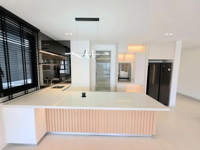 Kitchen features: white quartz countertop, kitchen island with wood paneling, black stainless-steel refrigerator, built-in oven, chrome pull-down faucet, single-bowl stainless-steel sink, black cabinetry, recessed LED downlights, pendant light fixture, sliding glass door, black window blinds; style: modern.