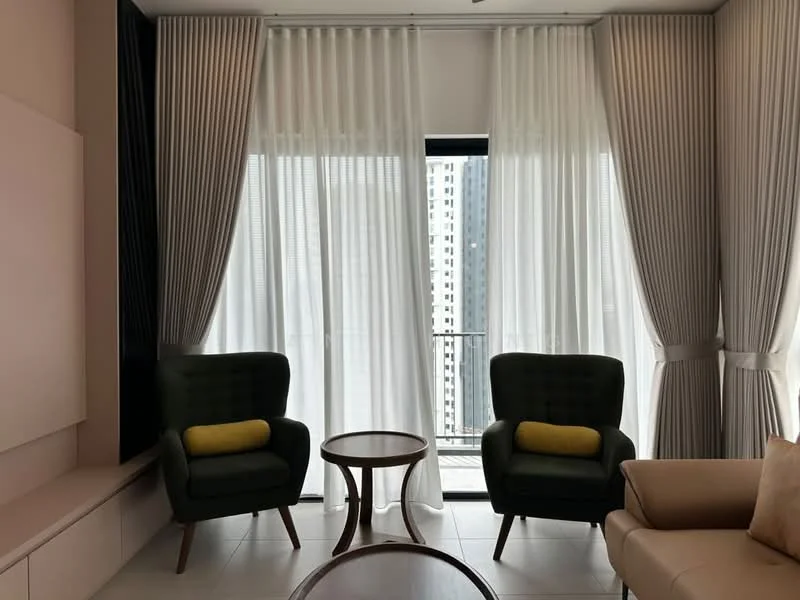 Living features: two green armchairs with yellow cushions, round wooden coffee table, floor-to-ceiling windows, sheer white curtains, blackout curtains, light-colored wall, light-colored flooring, wall-mounted TV unit, decorative wall paneling; style: modern; view: city.
