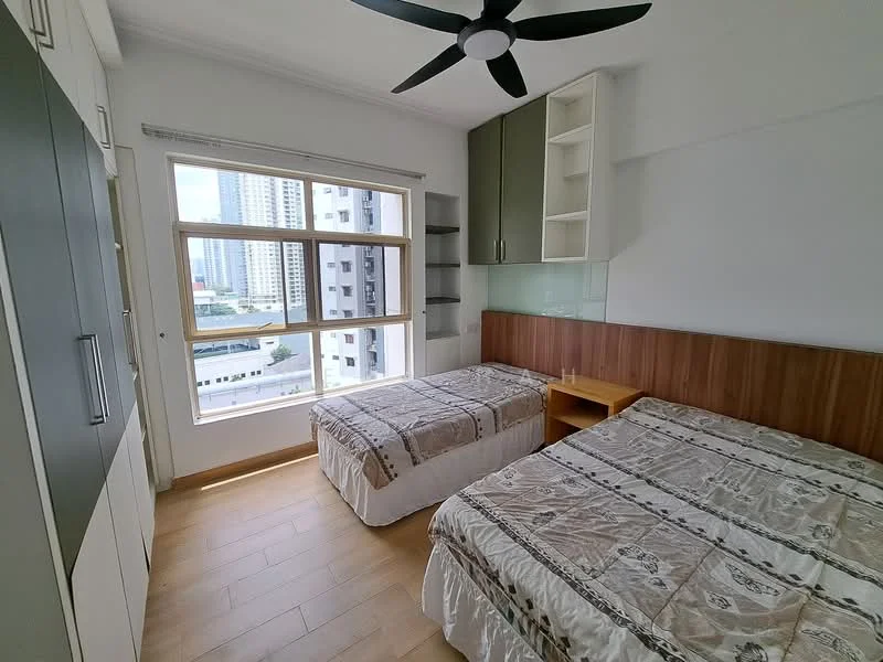 Bedroom features: two single beds with patterned bedspreads, wooden headboard, built-in wardrobe with sliding doors, green cabinetry above the bed, large window with city view, ceiling fan, laminate flooring, glass panel behind the headboard; style: modern; view: city.