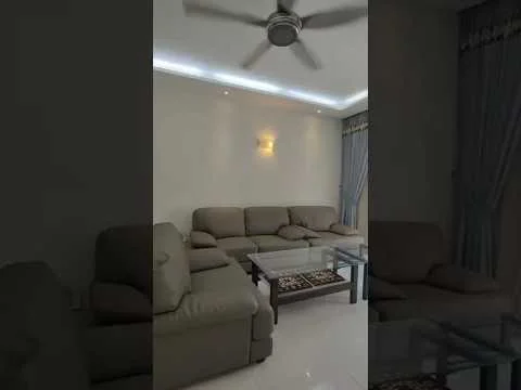 Living features: 3-seater fabric sofa in light grey, 2-seater fabric sofa in light grey, glass coffee table, recessed LED downlights, ceiling fan, light grey curtains, white painted walls, glossy tile flooring, decorative wall sconce; style: modern.