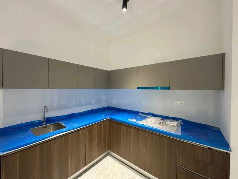 Kitchen features: L-shaped kitchen layout, brown wooden cabinetry, grey upper cabinets, stainless-steel sink, chrome faucet, blue protective covering on countertop, white walls, recessed lighting, tile flooring; style: modern.