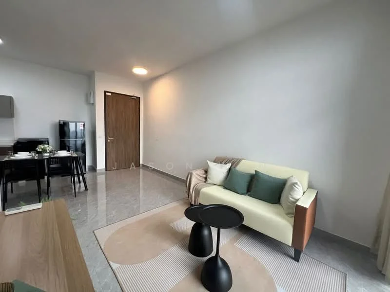Living features: light grey walls, marble tile flooring, sofa in light beige with green cushions, black side table, area rug with circular pattern, wall-mounted TV, dining table with black chairs, refrigerator in black, wooden door, large window with sheer curtains; style: modern.