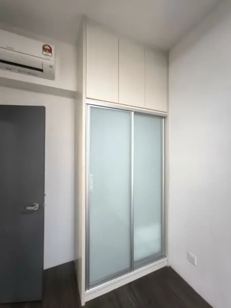 Room features: built-in wardrobe with sliding glass doors, white cabinetry, 1 wall-mounted split AC, grey door, dark wood laminate flooring, white painted walls; style: modern.