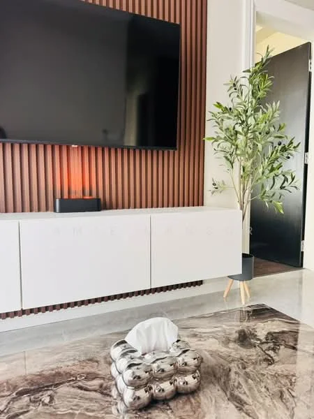 Living features: wall-mounted flat-screen TV, white low-profile media console, wood accent wall with vertical slats, marble flooring, decorative indoor plant in pot, tissue box holder, LED light source behind TV, neutral color palette; style: modern.