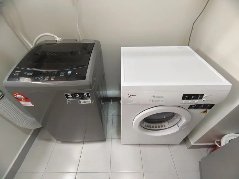 Laundry features: top-load washing machine in grey, front-load dryer in white, grey tiled flooring, ventilation duct, wall-mounted plumbing, circuit breaker panel, white walls, shelving unit.
