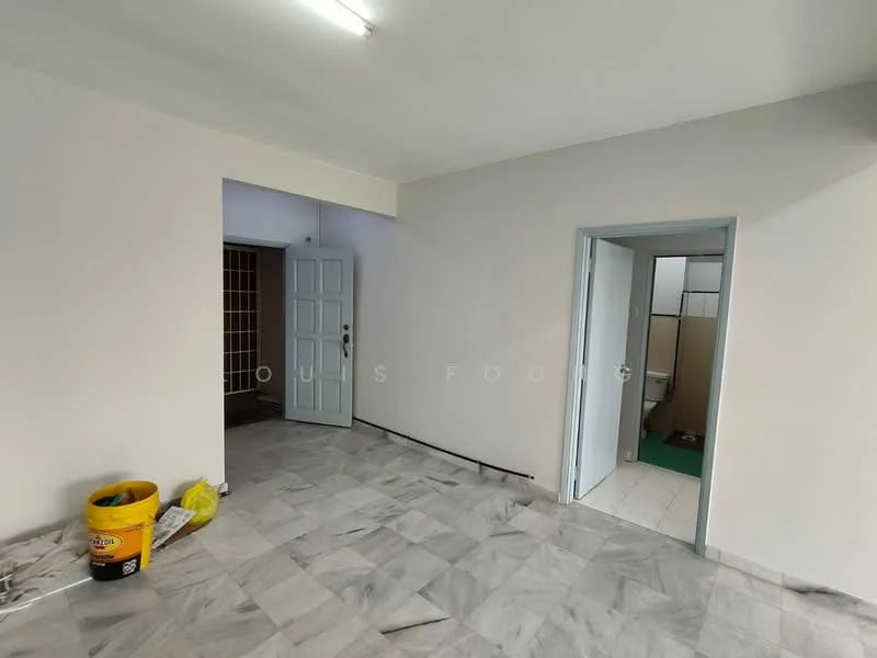 Room features: white painted walls, marble flooring, fluorescent ceiling lights, doorway leading to another room, doorway leading to a bathroom, unfinished space, bucket on the floor, yellow plastic bag on the floor.