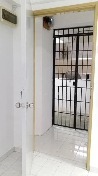 Room features: white painted walls, glossy white tile flooring, metal security grille door, wooden door frame, door handle, light fixture, visible wall-mounted electrical outlet; style: modern.