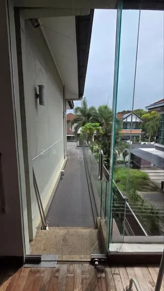 Room features: glass sliding door, wooden flooring, exterior wall with light fixture, balcony with glass railing, view of greenery, concrete flooring, overhang roof, paved walkway; style: modern; view: garden.