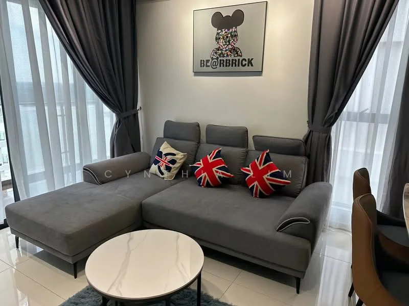 Living features: L-shape sectional sofa in grey, decorative cushions with Union Jack pattern, round coffee table with white top, floor-to-ceiling windows with sheer curtains, grey curtains, framed artwork on wall, glossy tile flooring, wall-mounted decor; style: modern.