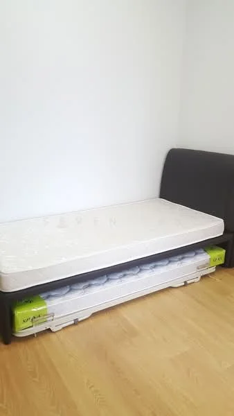 Bedroom features: single bed with mattress, black upholstered headboard, light wood flooring, white painted walls, storage under bed, minimalist decor; style: modern.