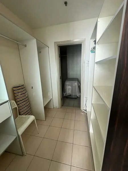 Room features: built-in shelving, open closet space, tile flooring, neutral wall color, chair, doorway leading to another room.