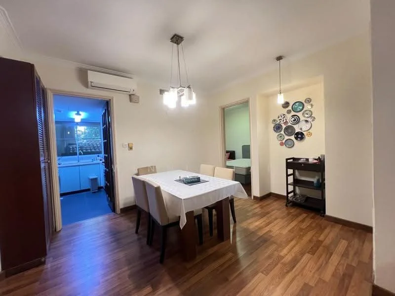Dining features: wooden flooring, white walls, dining table with white tablecloth, 4 dining chairs, 2 pendant lights, wall-mounted decorative plates, air conditioning unit, open doorway to kitchen, open doorway to hallway; style: modern. Kitchen features: blue tiled flooring, white cabinetry, countertop, appliances visible in background.