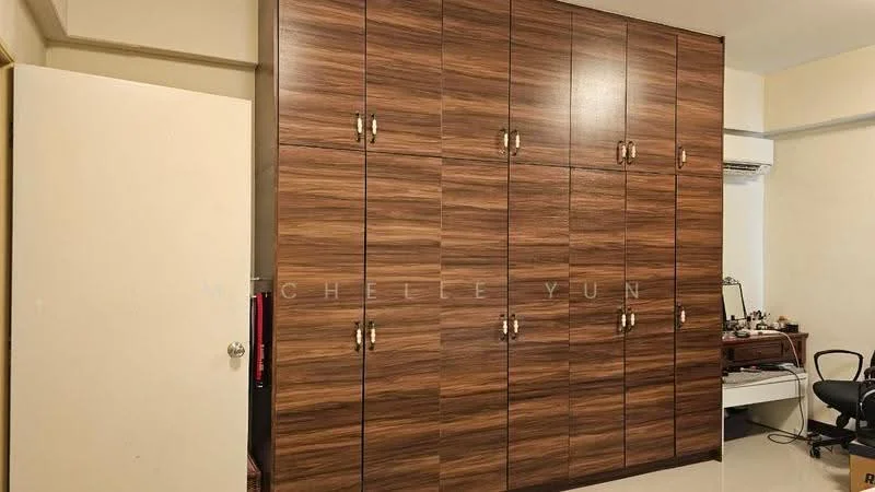 Room features: wooden wardrobe with multiple doors, light-colored walls, flooring with glossy finish, air conditioning unit on wall, desk with chair, mirror on desk; style: modern.