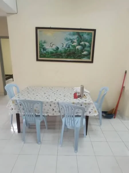 Dining features: square dining table with tablecloth, 4 blue plastic dining chairs, framed artwork on wall, white tiled flooring, light-colored painted walls, broom in corner.