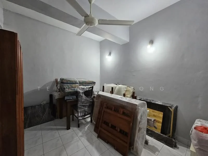 Room features: grey painted walls, white ceiling, 5-blade ceiling fan, white tiled flooring, various pieces of furniture covered in plastic, wooden furniture, stacked tables, seating cushions.