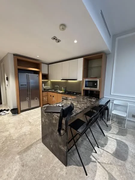 Kitchen features: marble countertop, stainless-steel fridge, built-in oven, freestanding microwave, white upper cabinets, wood lower cabinets, black bar stools, recessed LED downlights, tile flooring, kitchen island with seating, chrome faucet, double-bowl stainless-steel sink; style: modern.