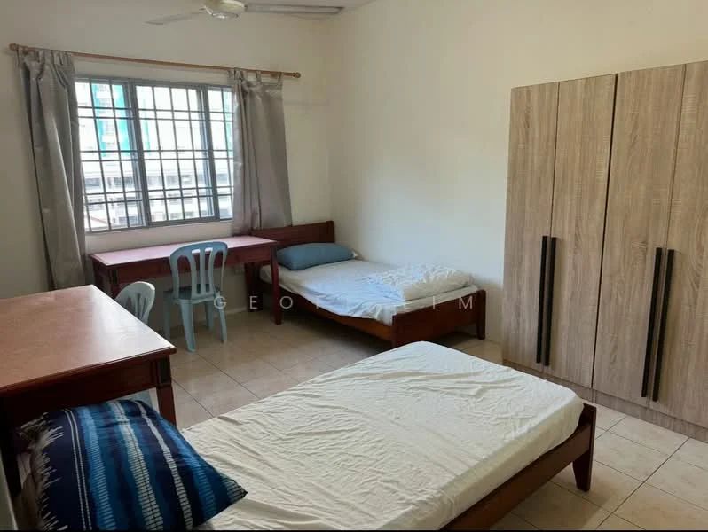 Bedroom features: two single beds, wooden bed frames, study desk, plastic chairs, window with grid pattern, curtains, light-colored walls, tiled flooring, ceiling fan.