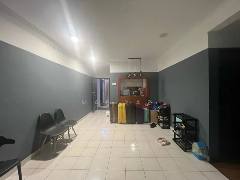 Room features: grey painted walls, white painted ceiling, tile flooring, recessed lighting, open layout, kitchen area visible in background, two black chairs, various colored luggage, black shelving unit, slippers on floor; style: modern.