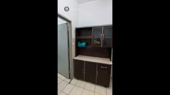 Room features: dark wood cabinetry, countertop with beige surface, open shelving, closed storage cabinets, tile flooring, neutral wall color, doorway leading to another room; style: modern.