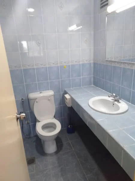 Bathroom features: blue tiled walls, blue tiled flooring, single-sink vanity with countertop, mirror above sink, one-piece toilet, flush tank, wall-mounted faucet, light fixture above mirror.