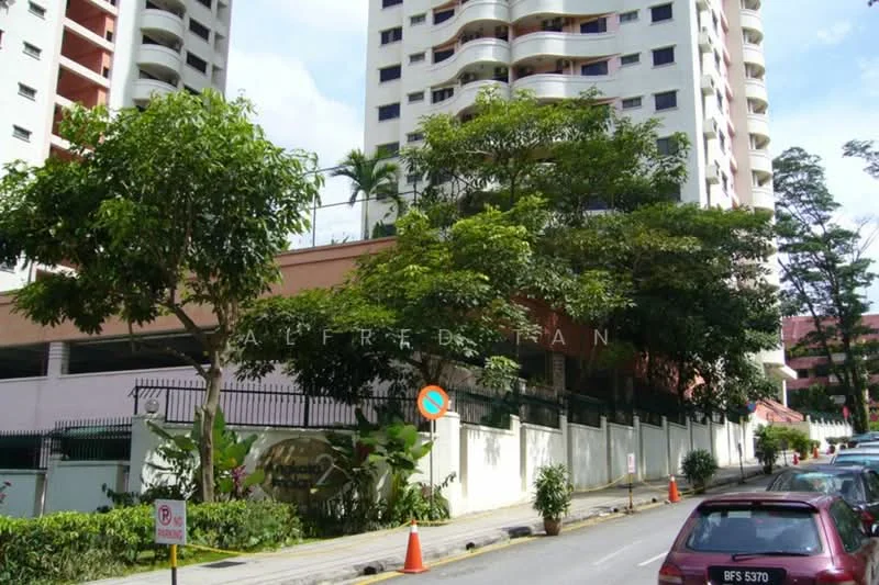 Exterior type: mid-rise condominium; features: white painted facade, curved balconies, landscaped garden with tropical plants, manicured lawn, parking deck visible, surrounded by mature trees, street view with parked cars, security gate at entrance; style: modern.