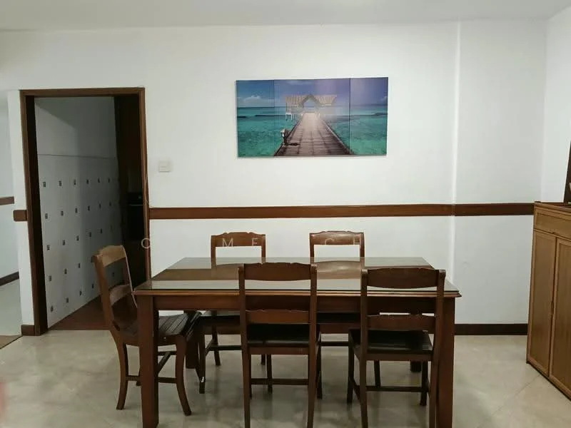 Dining features: wooden dining table, 6 wooden dining chairs, framed artwork on wall, white painted walls, tile flooring, wooden sideboard, wooden trim along wall; style: traditional. Room features: white painted walls, tile flooring, doorway leading to another room.