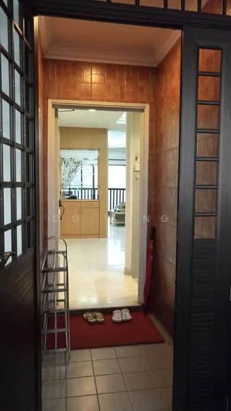Room features: tiled flooring, brown tiled walls, white door frame, open doorway leading to another room, red welcome mat, slippers on the floor, metal shoe rack, natural light from the doorway; style: modern.
