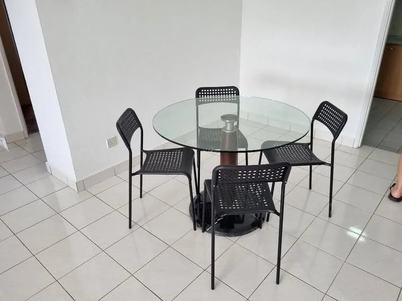 Dining features: round glass dining table, 4 black metal chairs with perforated backs, white painted walls, cream tiled flooring, natural light from nearby window, minimalist decor; style: modern.