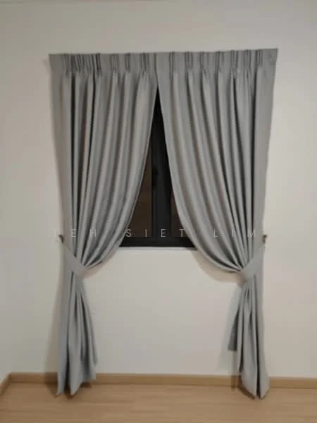 Room features: grey curtains, black window frame, wooden flooring, white painted walls.