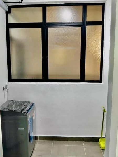 Laundry features: front-load washing machine, black framed window, white painted walls, grey tiled flooring, cleaning broom, water supply tap.
