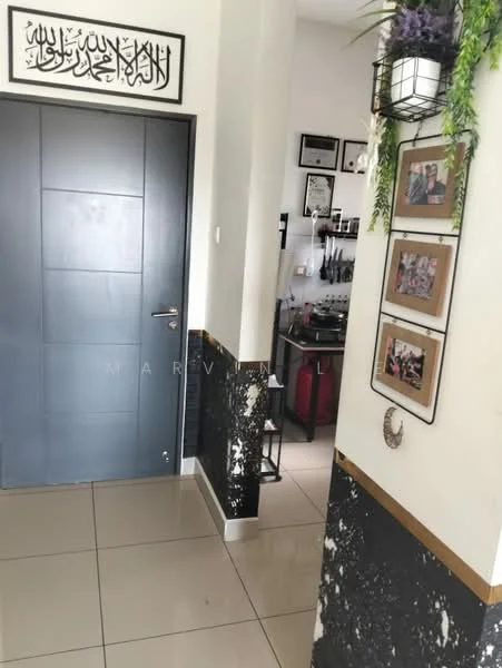 Room features: dark blue door, white walls, black and gold accent wall, glossy tile flooring, framed artwork on wall, hanging light fixture, decorative plants, kitchen visible in background; style: modern.