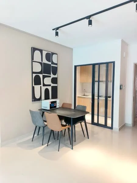 Dining features: dining table with black surface, 4 dining chairs in various colors, framed abstract artwork on wall, recessed ceiling lights, light-colored walls, tile flooring, glass partition leading to kitchen, microwave on table; style: modern. Kitchen features: wood cabinetry, white countertops, built-in appliances, open layout to dining area; style: modern.