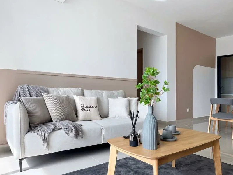 Living features: 3-seater fabric sofa in light grey, decorative throw pillows in various shades, wooden coffee table, ceramic vase with greenery, black decorative items, area rug in dark grey, white painted walls, accent wall in beige, recessed ceiling lights, floor-to-ceiling windows, light-colored tiled flooring; style: modern.