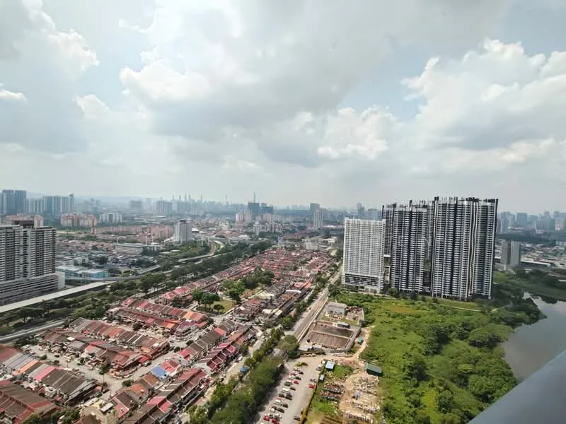 Exterior type: high-rise condominium; features: city skyline view, surrounded by greenery, urban landscape, multiple residential buildings, road infrastructure visible, water body in the foreground; style: modern.