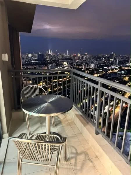 Balcony features: metal railing, round glass-top table, two metal chairs, ceramic tile flooring, city skyline view, night lighting; style: modern; view: city.