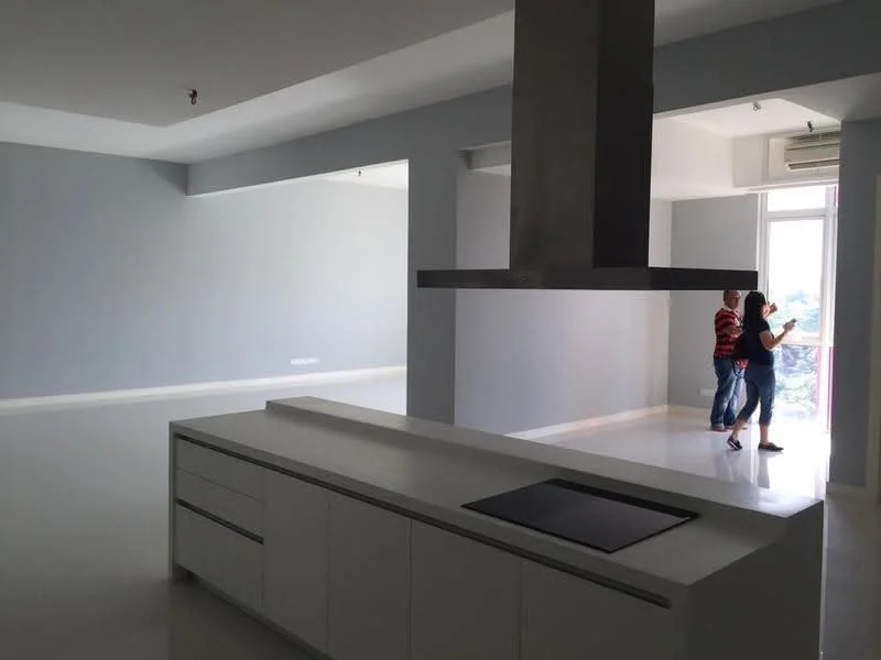 Kitchen features: white cabinetry, island with built-in cooktop, stainless-steel range hood, white glossy countertop, open layout, recessed downlights, polished tile flooring, grey painted walls; style: modern; view: city. Living features: large windows, natural light, grey painted walls, polished tile flooring, open layout, recessed downlights; style: modern; view: city.