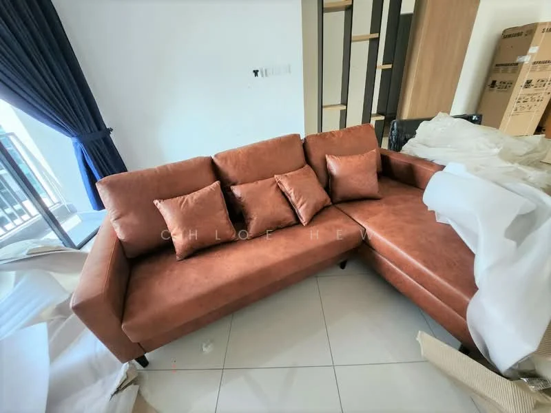 Living features: L-shape sectional sofa in brown, 4 decorative cushions, white walls, large window with blue curtains, tile flooring, wood shelving unit, cardboard boxes in background, decorative items partially covered with white fabric; style: modern.