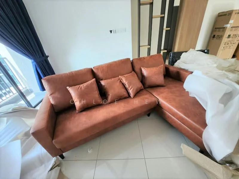Living features: L-shape sectional sofa in brown fabric, four decorative cushions, white walls, large window with blue curtains, glossy tile flooring, wooden shelving unit, cardboard boxes in background, decorative items partially covered with white fabric; style: modern.