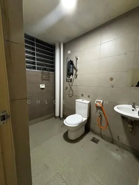 Bathroom features: one-piece toilet, wall-mounted shower with adjustable head, sink with wall-mounted faucet, grey tiled walls, grey tiled flooring, window for natural light, exposed plumbing, mirror above sink.