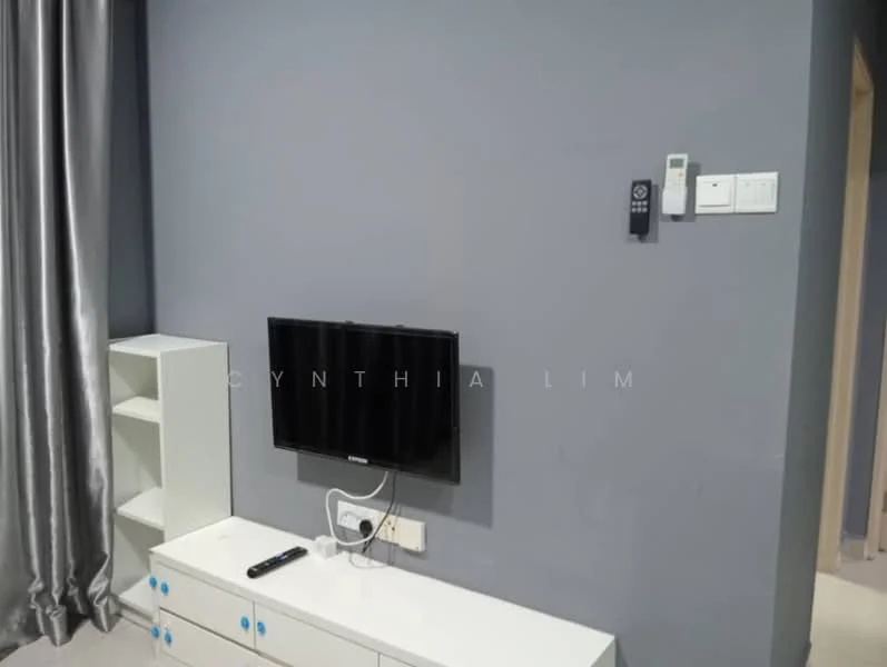 Room features: grey painted walls, wall-mounted TV, white TV console, remote control, shelving unit, curtains, flooring not visible.