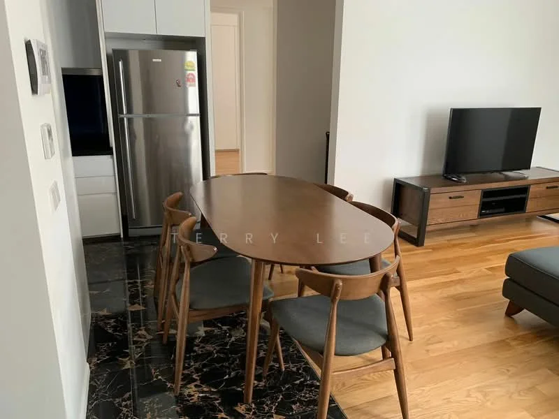 Dining features: round wooden dining table, 4 wooden dining chairs with grey cushions, black marble flooring, light grey painted walls, stainless-steel fridge, wooden TV console, wall-mounted TV; style: modern.