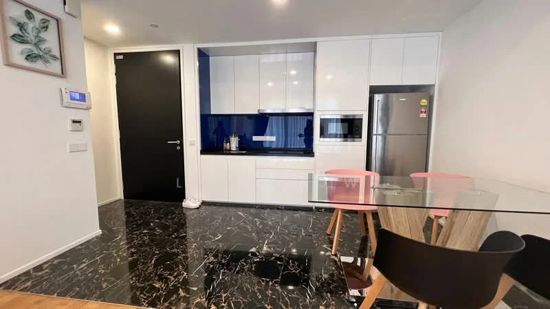 Kitchen features: black marble flooring, white cabinetry with flat-panel design, blue backsplash, built-in microwave, stainless-steel fridge, built-in oven, glass dining table, black dining chairs, pink dining chairs, recessed downlights, wall-mounted switches, black door; style: modern.