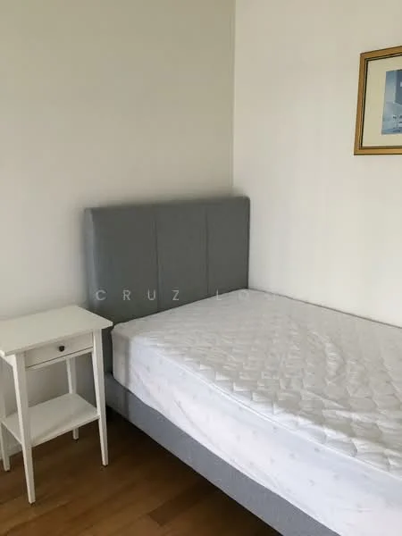 Bedroom features: grey upholstered headboard, single bed, white bed frame, wooden bedside table, framed artwork on wall, light wood flooring, white painted walls; style: minimalist.