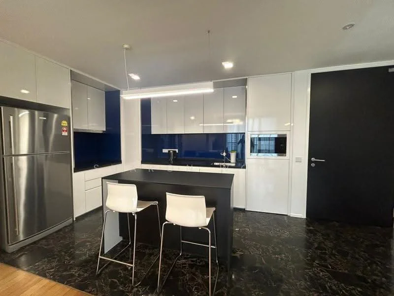 Kitchen features: black marble flooring, white cabinetry with flat-panel design, blue glass backsplash, black kitchen island with seating for two, stainless-steel fridge, built-in oven, stainless-steel sink, chrome pull-down faucet, recessed LED downlights, pendant light above island, open shelving, wall-mounted microwave; style: modern.