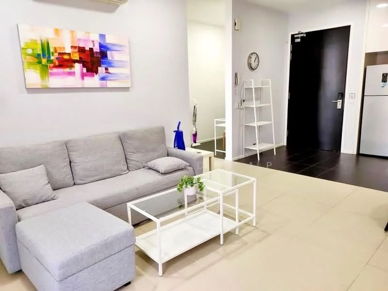 Living features: grey fabric sofa, white coffee table with glass top, area rug, wall-mounted clock, abstract artwork on wall, floor-to-ceiling windows, light-colored walls, tile flooring, air conditioning unit, open shelving unit, doorway leading to hallway, refrigerator visible in background; style: modern.