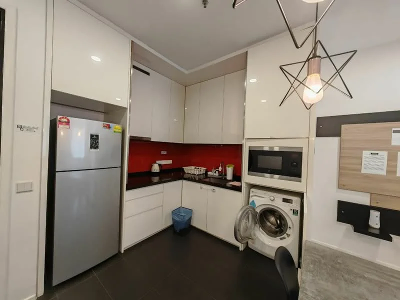 Kitchen features: white high-gloss cabinetry, red backsplash, stainless-steel fridge, built-in microwave, built-in washing machine, black countertop, single-bowl stainless-steel sink, chrome pull-down faucet, recessed downlights, pendant light fixture, black tile flooring; style: modern.