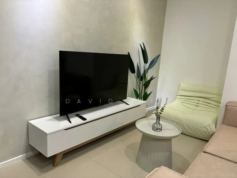 Living features: light grey painted walls, cream sofa, white TV console with wooden legs, large flat-screen TV, round coffee table with a textured surface, green indoor plant, decorative vase with greenery, beige lounge chair; style: modern.