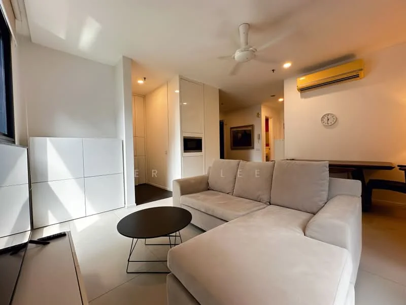 Living features: light grey fabric sectional sofa, black coffee table, wall-mounted TV, white cabinetry, recessed downlights, ceiling fan, large window with natural light, cream painted walls, tile flooring, dining table visible in background; style: modern.